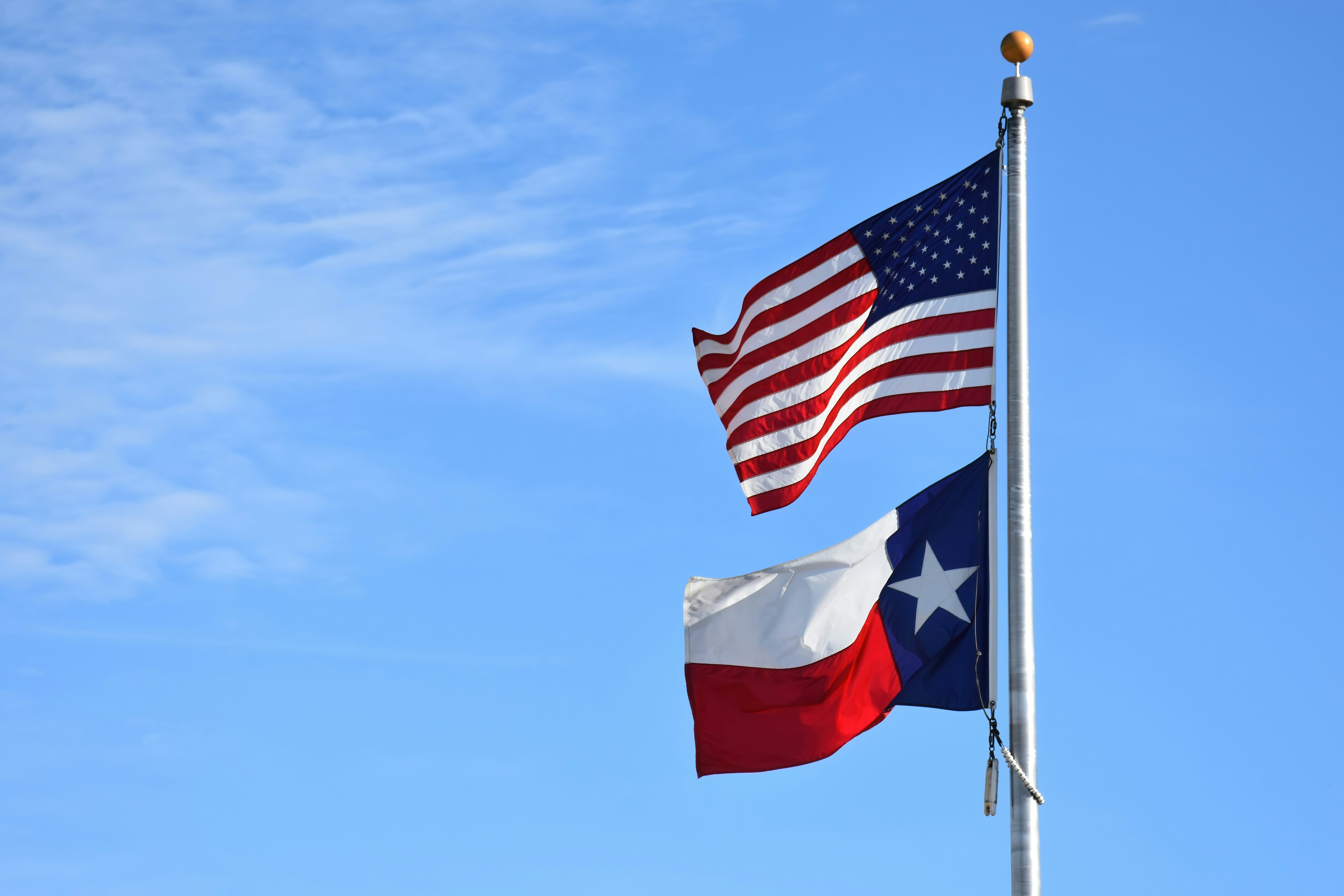 United States and Texas flags flying together